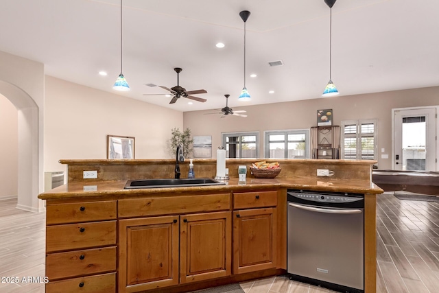 kitchen with sink, hanging light fixtures, dishwasher, an island with sink, and light hardwood / wood-style floors