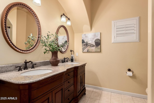 bathroom with tile patterned flooring, vanity, and toilet