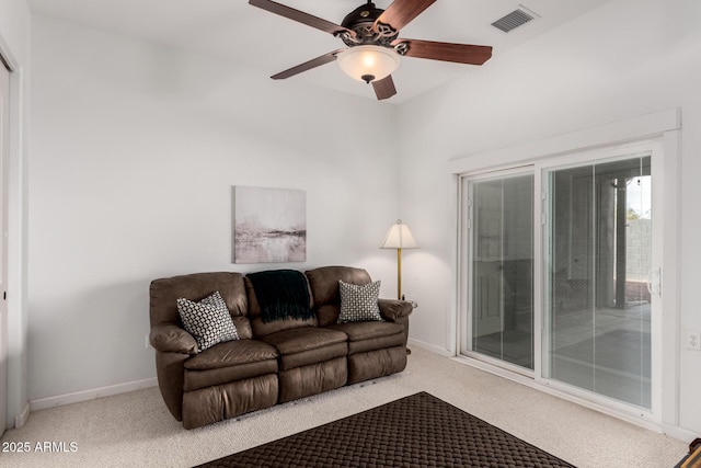 carpeted living room featuring ceiling fan