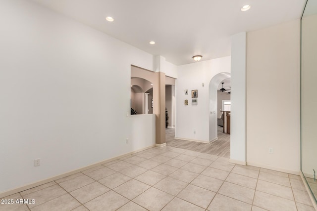 empty room featuring light tile patterned floors and ceiling fan