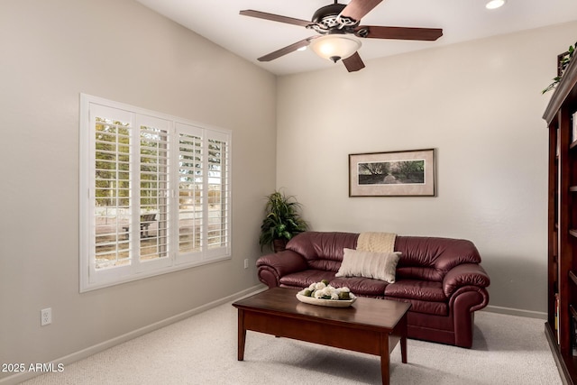 carpeted living room featuring ceiling fan