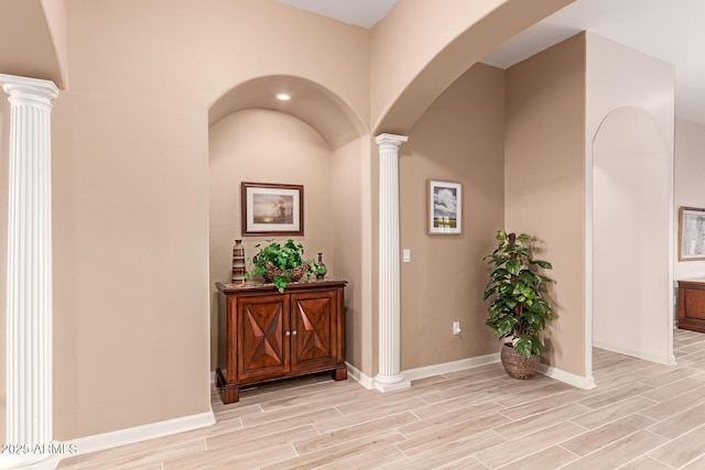 hallway featuring decorative columns