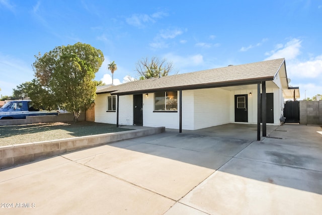 ranch-style home with a carport