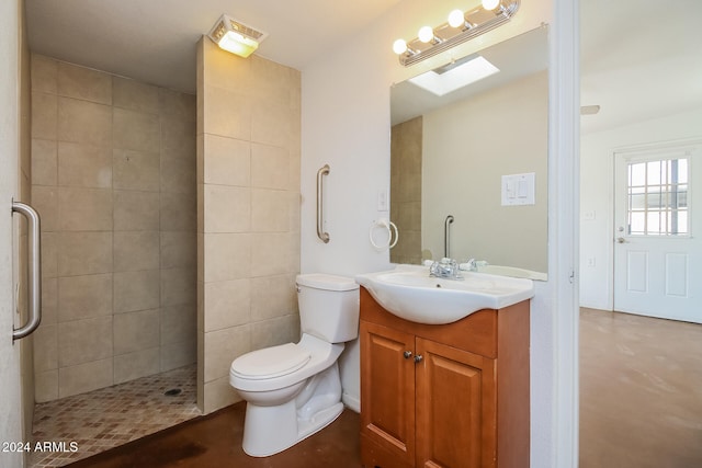 bathroom featuring a skylight, vanity, concrete floors, and toilet