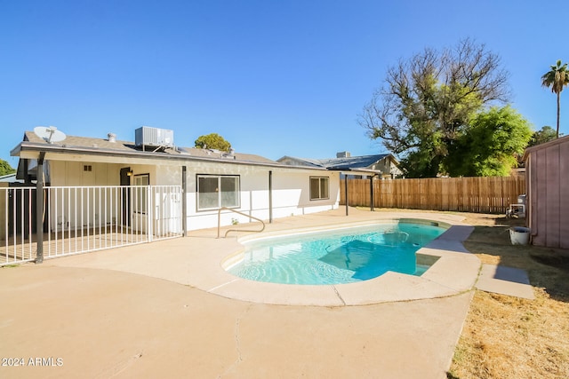 view of pool featuring cooling unit and a patio area