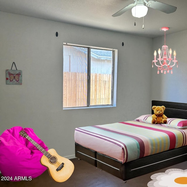 bedroom featuring ceiling fan with notable chandelier