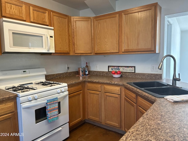 kitchen featuring white appliances and sink