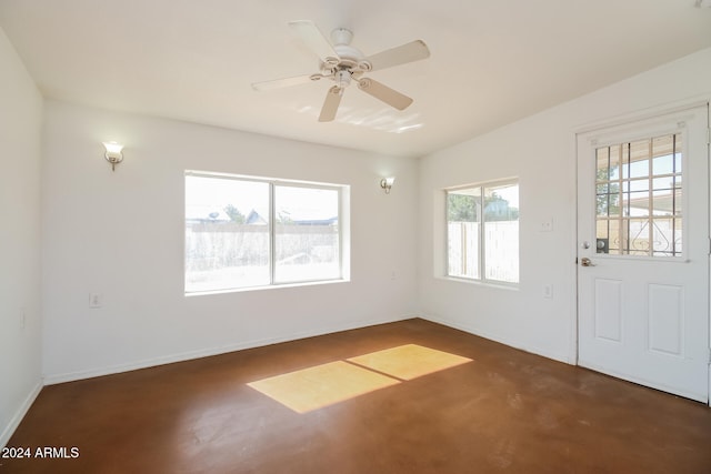 interior space with ceiling fan, a healthy amount of sunlight, lofted ceiling, and dark carpet