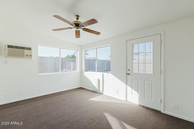 interior space featuring a wall mounted air conditioner and ceiling fan