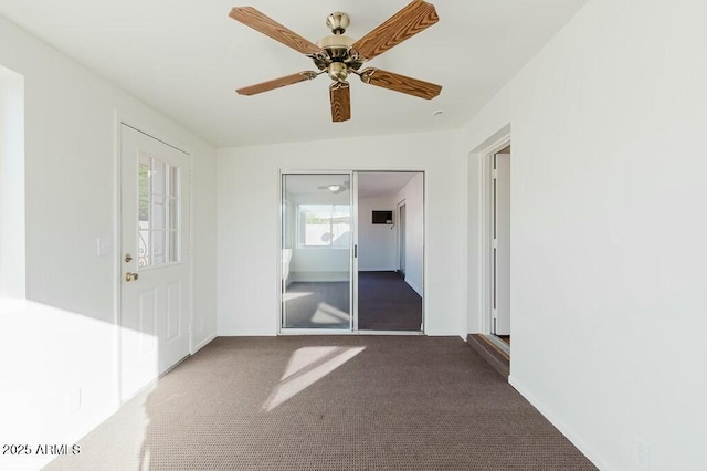 interior space with carpet flooring and ceiling fan