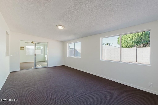 unfurnished bedroom featuring dark carpet and a textured ceiling