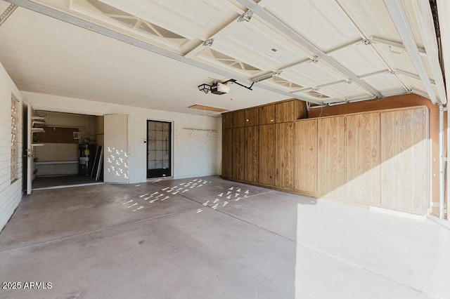 garage featuring a garage door opener and water heater