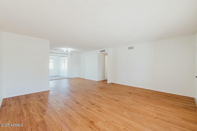 spare room with light hardwood / wood-style floors