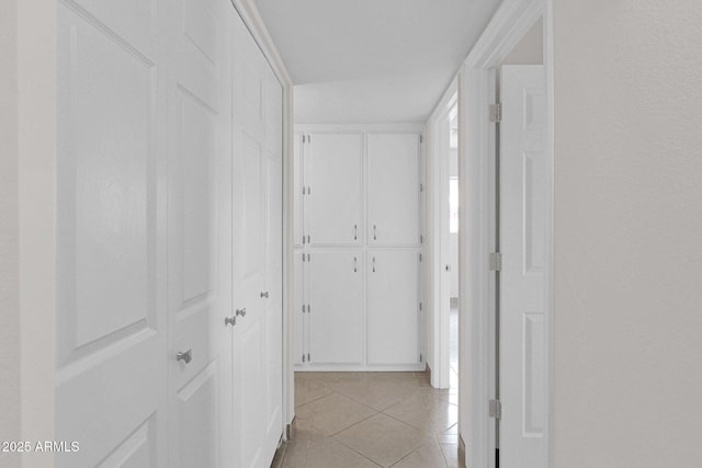 corridor featuring light tile patterned floors