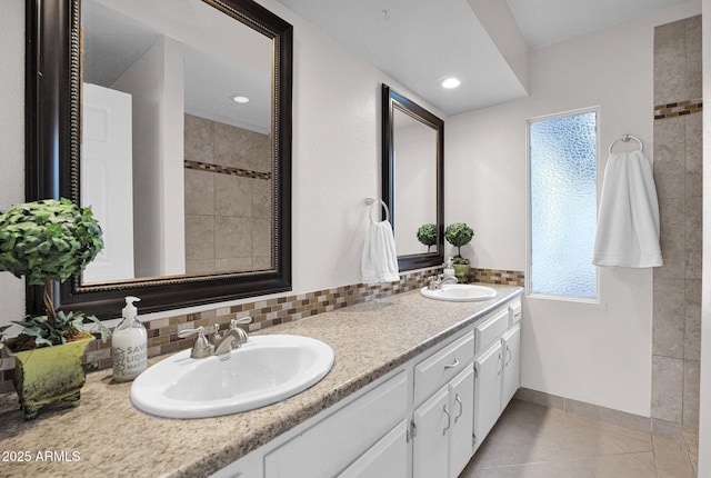 full bath featuring plenty of natural light, a sink, and tile patterned floors