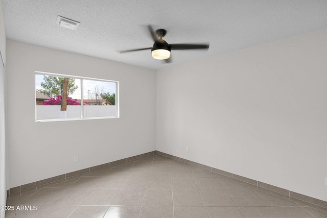 empty room featuring ceiling fan and a textured ceiling