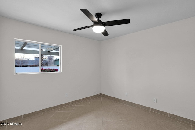 unfurnished room with tile patterned flooring and a ceiling fan