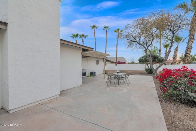 view of patio with outdoor dining space and a fenced backyard