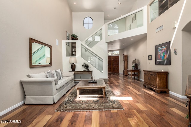 7955 E Chaparral Rd Unit 17, Scottsdale, AZ 85250 - living room featuring wood finished floors, a towering ceiling, stairway, and recessed lighting