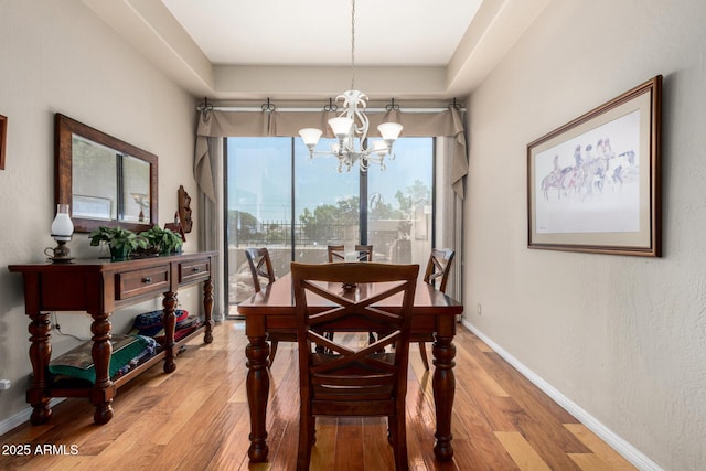 7955 E Chaparral Rd Unit 17, Scottsdale, AZ 85250 - dining area with a chandelier and light wood-style floors