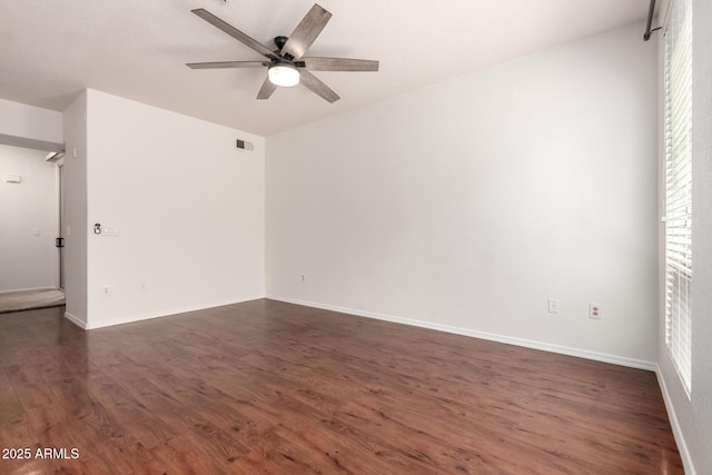 unfurnished room with visible vents, baseboards, ceiling fan, and dark wood-style floors