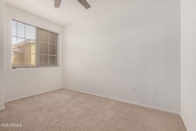 empty room with carpet, baseboards, and a ceiling fan