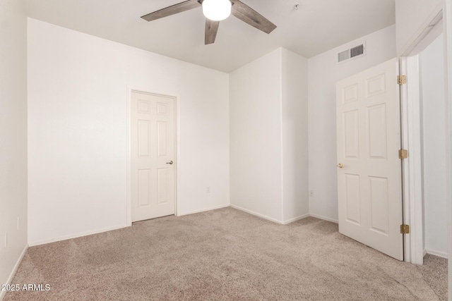 spare room featuring a ceiling fan, baseboards, visible vents, and carpet floors