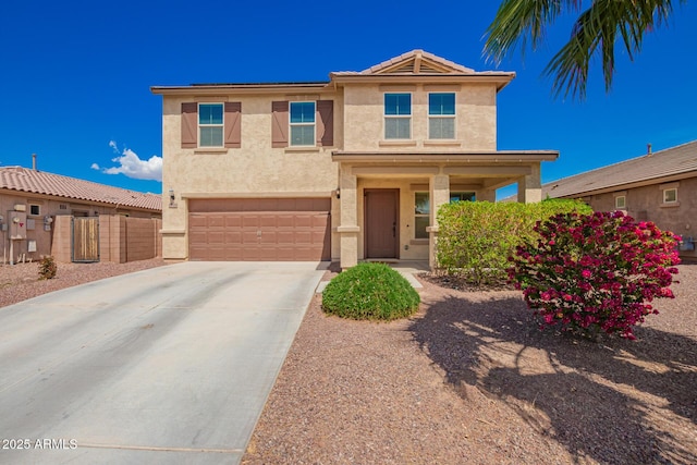 view of front of home with an attached garage, concrete driveway, stucco siding, and fence