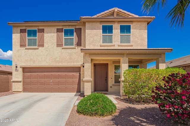 view of front facade with an attached garage, driveway, stucco siding, and a tile roof