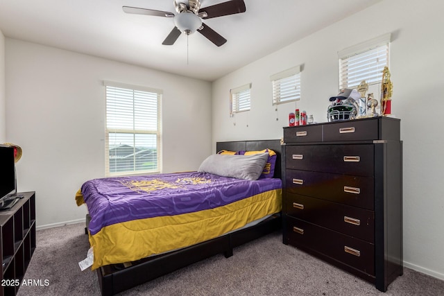 bedroom with ceiling fan, baseboards, and carpet