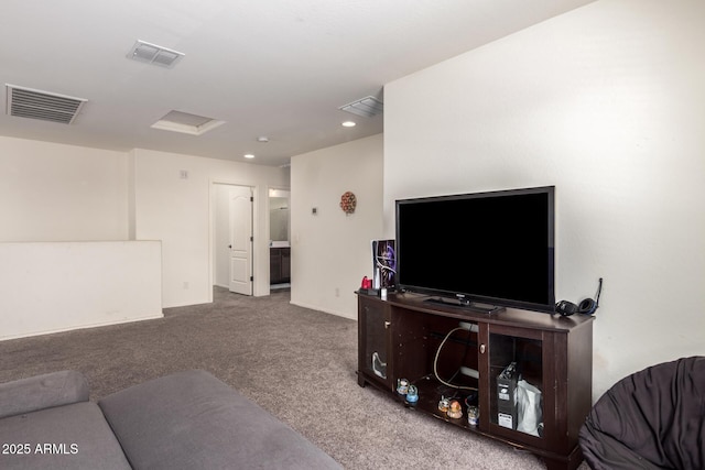 carpeted living area featuring recessed lighting, visible vents, and attic access