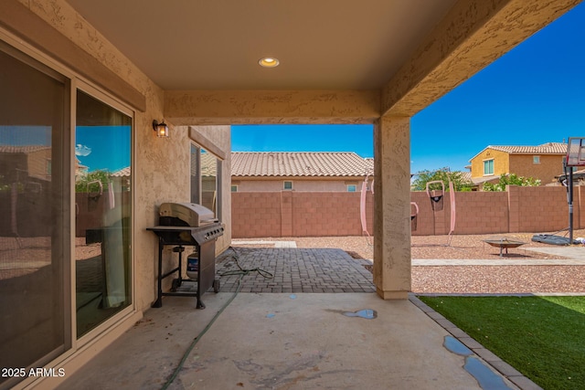 view of patio with a fenced backyard and a grill