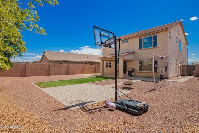 back of property featuring a fenced backyard, a fire pit, a patio, and stucco siding