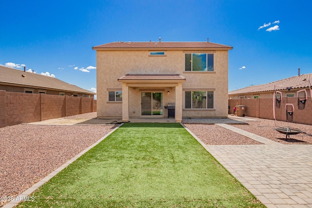 back of house with a patio area, stucco siding, and a fenced backyard