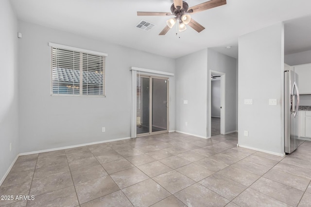 11505 W Boca Raton Rd, El Mirage, AZ 85335 - unfurnished bedroom with freestanding refrigerator, a walk in closet, light tile patterned flooring, and a closet