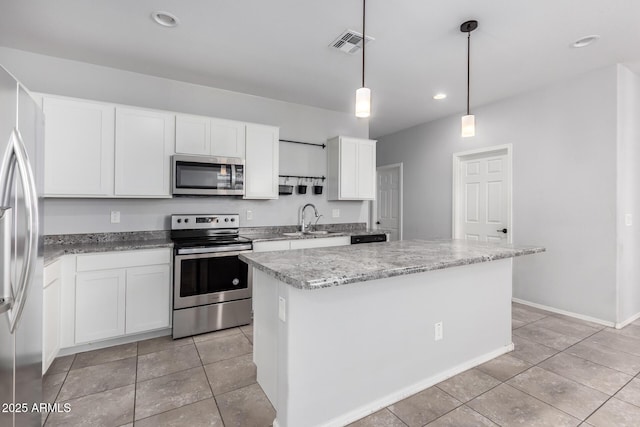 11505 W Boca Raton Rd, El Mirage, AZ 85335 - kitchen with appliances with stainless steel finishes, a sink, a center island, white cabinets, and light tile patterned floors