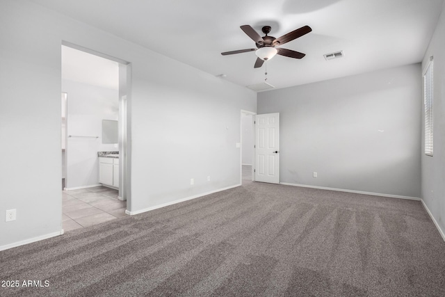 11505 W Boca Raton Rd, El Mirage, AZ 85335 - unfurnished bedroom with light carpet, baseboards, connected bathroom, and ceiling fan