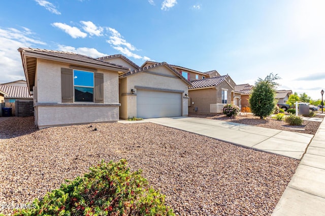 11505 W Boca Raton Rd, El Mirage, AZ 85335 - view of front of home with driveway, a garage, a tiled roof, stucco siding, and fence