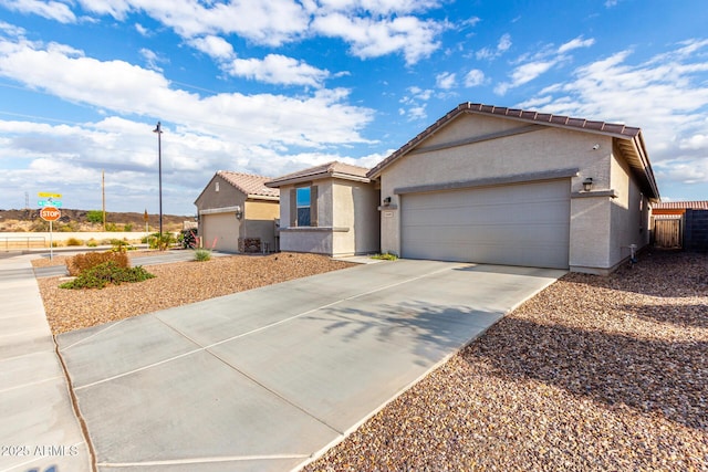 11505 W Boca Raton Rd, El Mirage, AZ 85335 - ranch-style home with concrete driveway, an attached garage, stucco siding, and a tiled roof