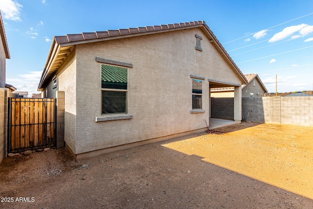 11505 W Boca Raton Rd, El Mirage, AZ 85335 - rear view of property featuring stucco siding, fence, and a patio area