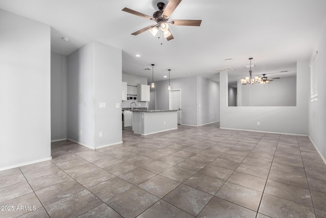 11505 W Boca Raton Rd, El Mirage, AZ 85335 - unfurnished living room with a chandelier, a ceiling fan, a sink, baseboards, and tile patterned floors