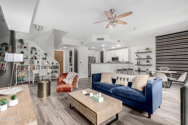 living room featuring light wood-type flooring and ceiling fan