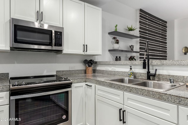 kitchen featuring white cabinetry, sink, and appliances with stainless steel finishes