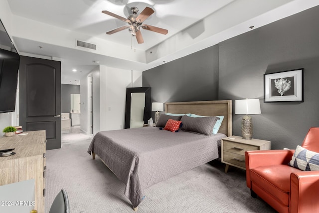 carpeted bedroom featuring ensuite bathroom and ceiling fan