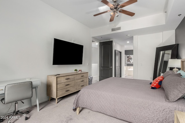 bedroom featuring connected bathroom, ceiling fan, and light colored carpet