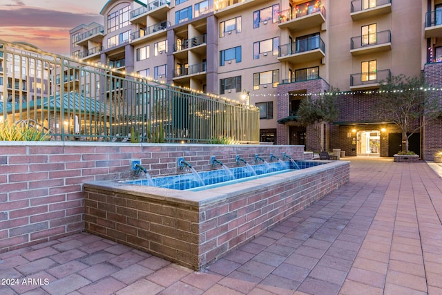 view of pool at dusk