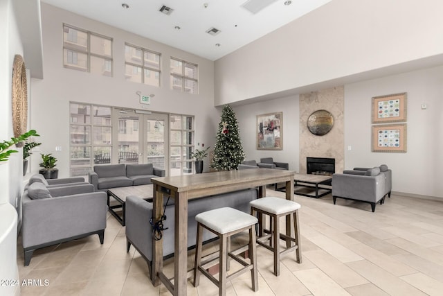 interior space with a fireplace and a towering ceiling