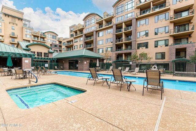 view of pool featuring a patio and a hot tub