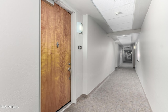 corridor featuring a paneled ceiling