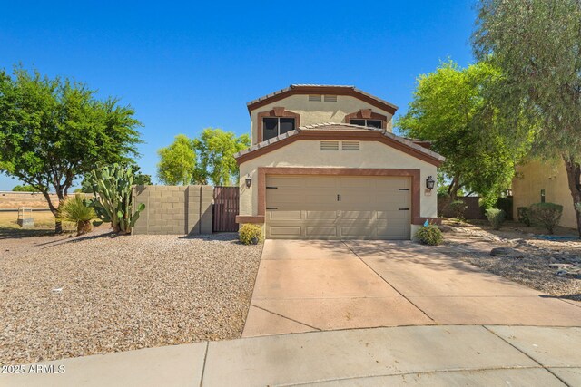 view of front of property featuring fence, stucco siding, a garage, and driveway